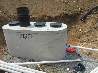 Precast septic tank installed prior to backfill for a septic application.